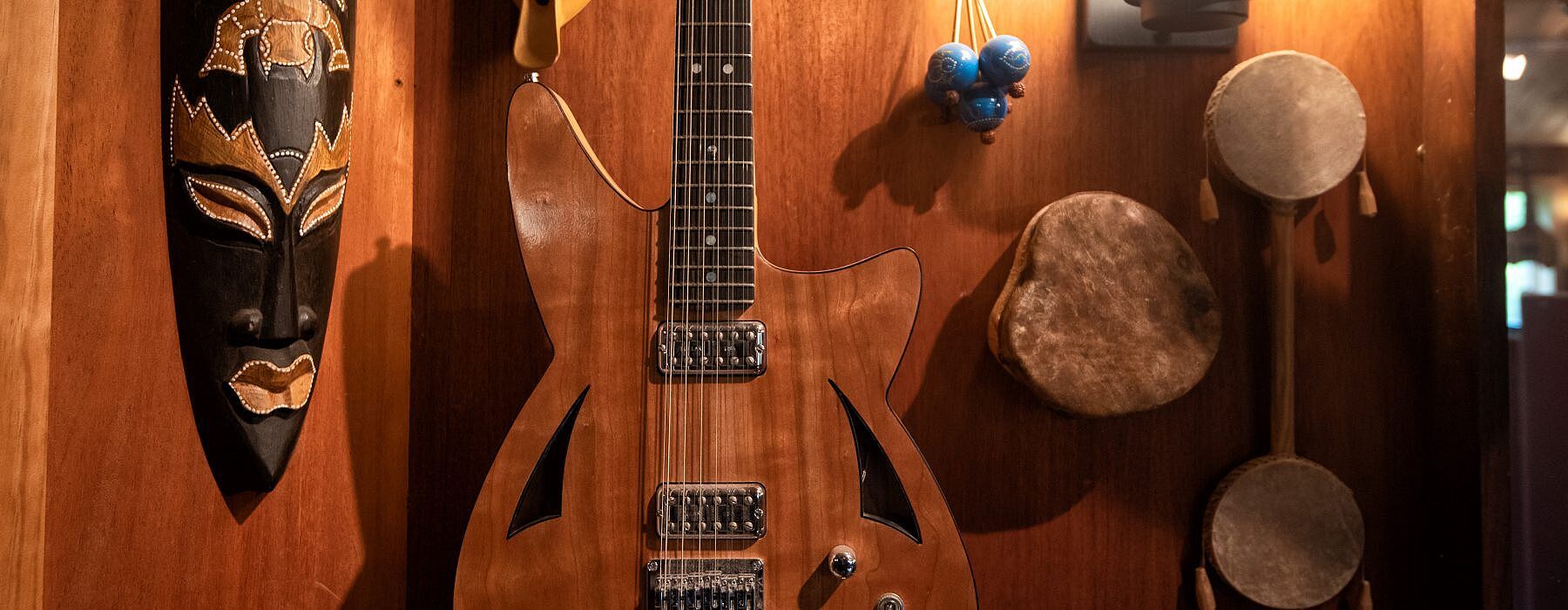 Custom electric guitar hanging on the wall at Possum Hall Studio