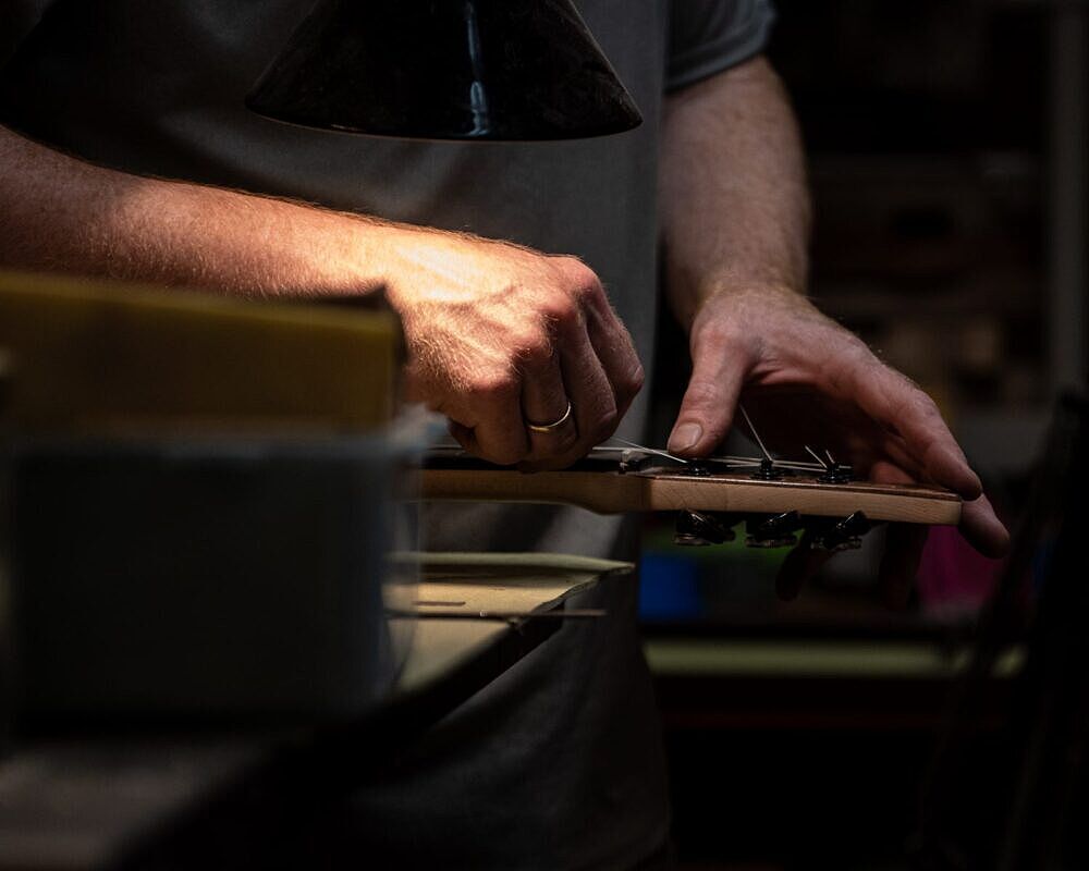 Mac Ritchey stringing a custom guitar