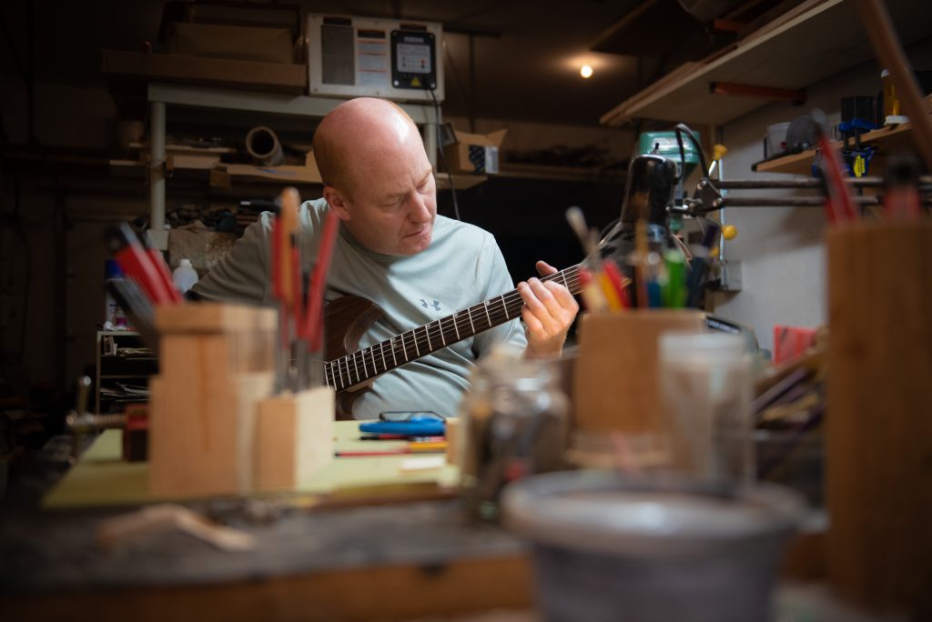 Mac Ritchey, luthier, working on an instrument in his shop in Carlisle, MA