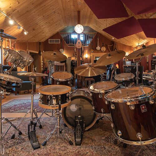 view from behind the drum kit into the room with a 13 foot high cathedral ceiling