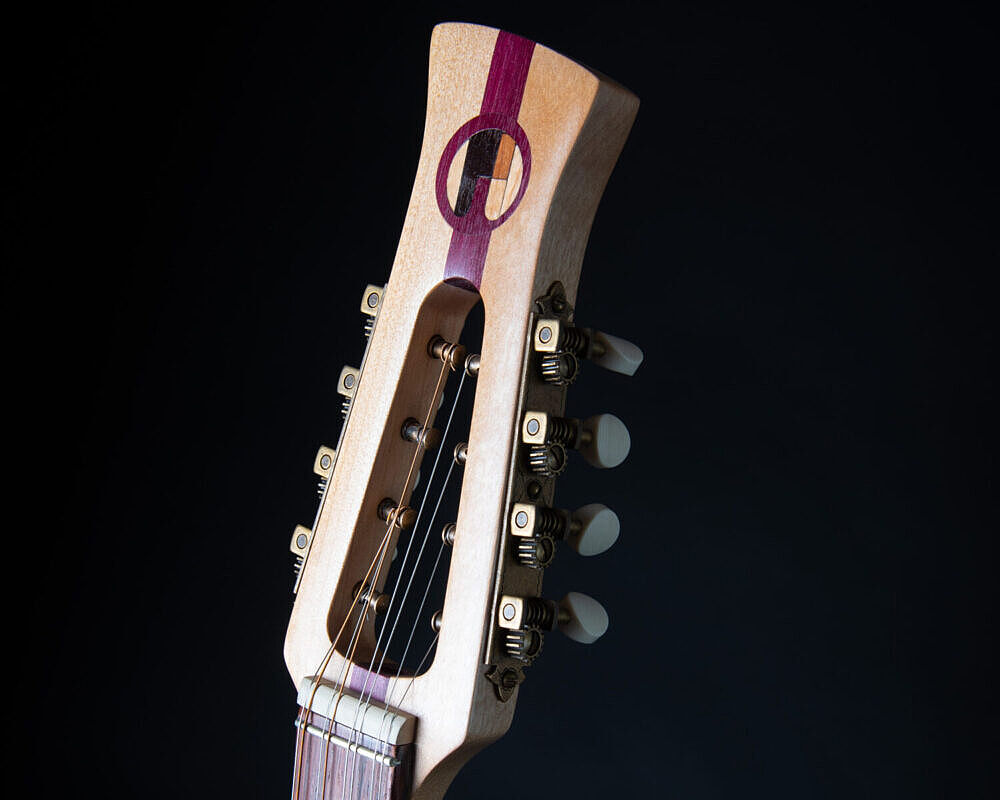 headstock of bouzouki showing logo detail and purple heart stripe