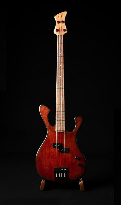 custom illusionist bass four string, red alder body, single p pickup